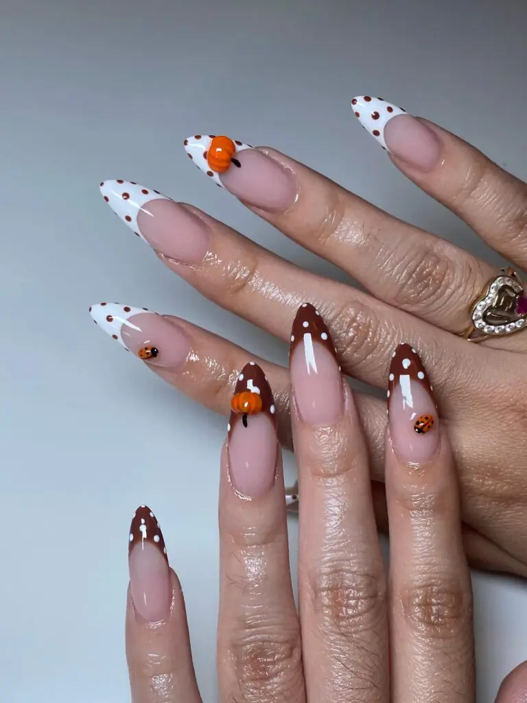 For a softer Halloween manicure, use a milky base with delicate black-and-white details and little pops of orange. The result is cute rather than frightening, and it works beautifully on almond or stiletto extensions. I love this idea for anyone who wants seasonal nails but still reaches for cream sweaters, blush makeup, and warm neutrals the rest of the month.