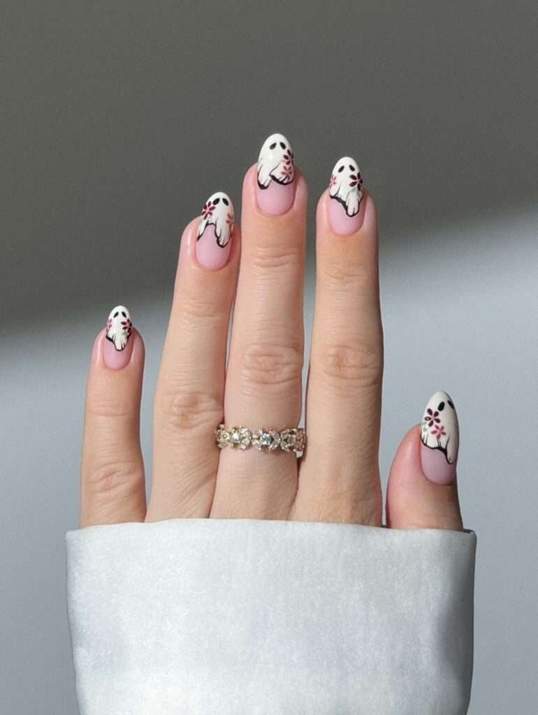 Mini Ghost French Tips. Tiny ghost faces on a sheer nude base are proof that Halloween nails can be subtle. The white tips elongate the fingers, and the little expressions give the set just enough personality without taking over your outfit. I would choose this for the office, a weekend trip, or anyone who wants seasonal detail that is still very easy to live with.