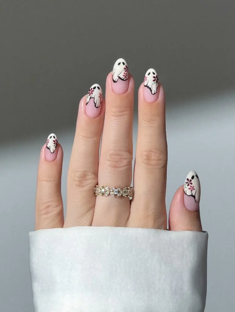 Mini Ghost French Tips. Tiny ghost faces on a sheer nude base are proof that Halloween nails can be subtle. The white tips elongate the fingers, and the little expressions give the set just enough personality without taking over your outfit. I would choose this for the office, a weekend trip, or anyone who wants seasonal detail that is still very easy to live with.