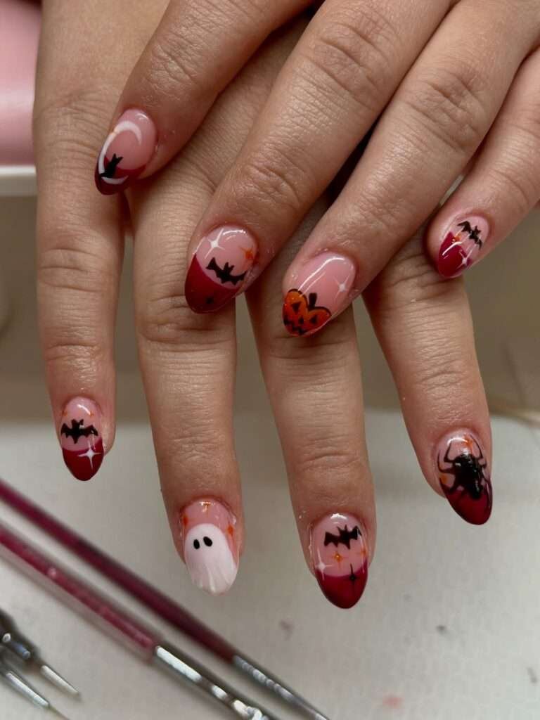 Bloody Cherry Micro-Art. For a manicure with a little bite, use a sheer base and scatter tiny cherry-red motifs across the nails. The artwork feels delicate from a distance, but close up it has that cheeky Halloween energy we want in October. It is a great way to experiment with nail art if a full graphic set feels like too much.