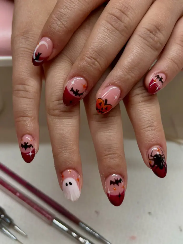 Bloody Cherry Micro-Art. For a manicure with a little bite, use a sheer base and scatter tiny cherry-red motifs across the nails. The artwork feels delicate from a distance, but close up it has that cheeky Halloween energy we want in October. It is a great way to experiment with nail art if a full graphic set feels like too much.