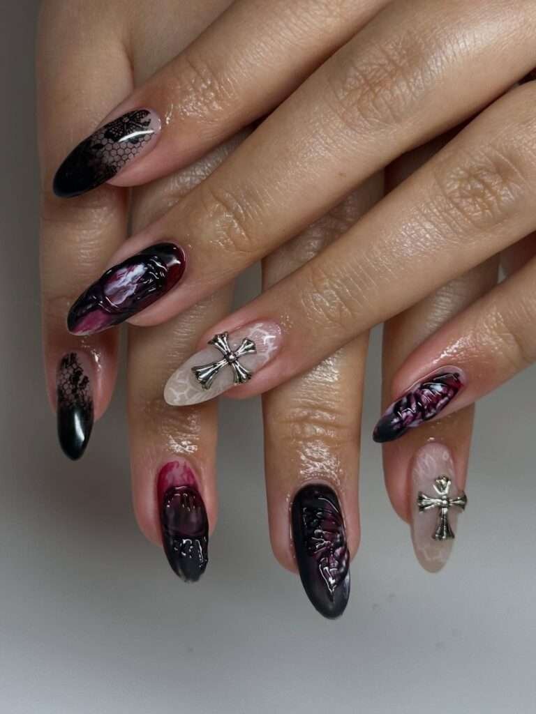 This is the manicure I picture with black boots, a leather jacket, and a late dinner reservation. Garnet, black, and glitter create a rich gothic mood without relying on literal Halloween symbols. The mix of reflective finishes keeps the darker palette dimensional and gives every nail a different flash when you move your hands.
