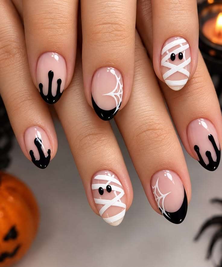 If you love Halloween but still want your manicure to feel pretty, this playful mix is such a sweet compromise. A sheer blush base keeps the look soft; glossy black drips and cobweb French tips bring the spooky mood, while a tiny white mummy face gives you one little character moment.