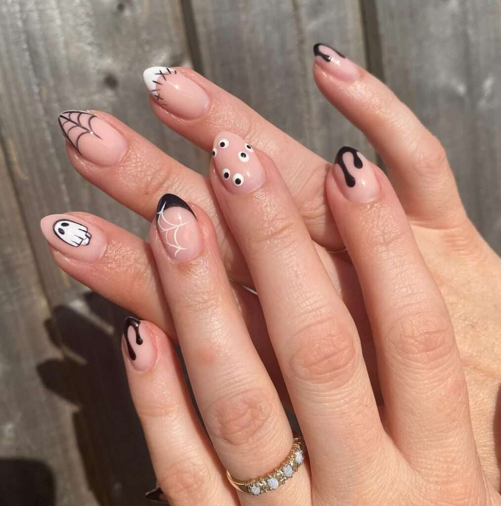 Pumpkins and spiderwebs are Halloween classics, but here both details stay tiny. Blush polish softens the palette, pumpkin orange adds a happy pop, and a fine black web keeps the look from feeling too sweet. It is an easy October manicure to pair with everyday outfits.