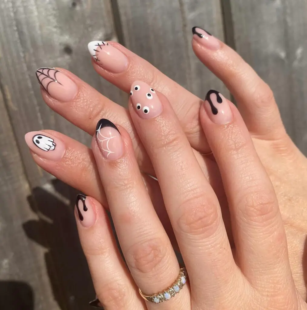 Pumpkins and spiderwebs are Halloween classics, but here both details stay tiny. Blush polish softens the palette, pumpkin orange adds a happy pop, and a fine black web keeps the look from feeling too sweet. It is an easy October manicure to pair with everyday outfits.