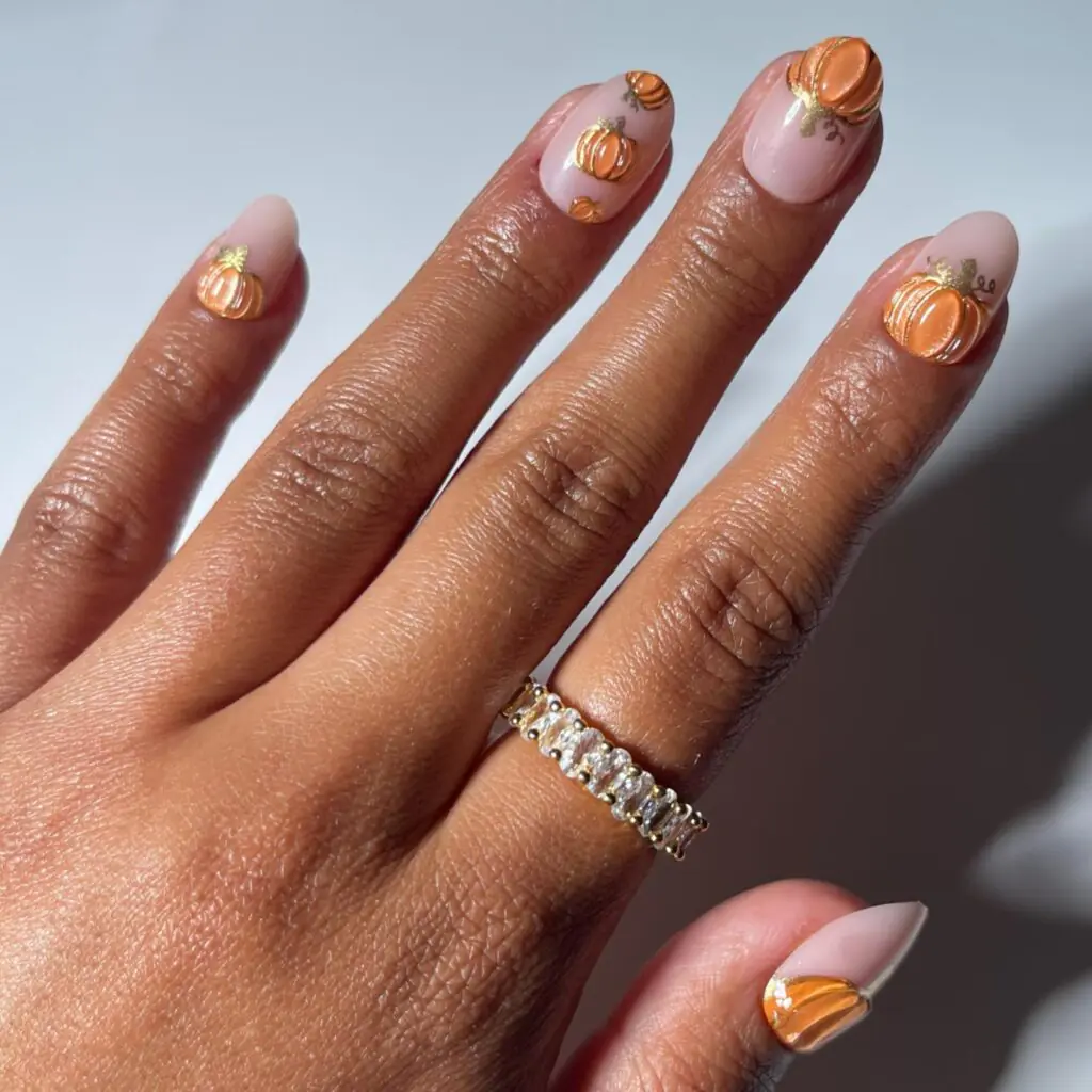 These tiny raised pumpkins are almost jewelry for your nails. A pale blush base feels clean and feminine, while the glossy orange details bring the unmistakable feeling of October. I love this idea with gold rings, cozy knits, or a dressed-up fall outfit.