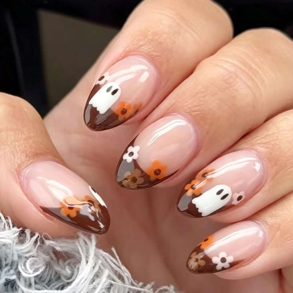 This is Halloween with a soft vintage filter. Chocolate French tips frame the blush base, and tiny white ghosts mingle with warm orange flower details. It feels a little spooky, a little sweet, and will still look lovely when October turns into November.