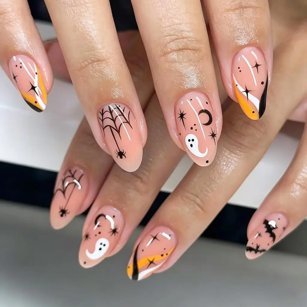 A translucent pink base, tiny ghost, pumpkin, and web details make this set feel soft and charming rather than costume-like. From up close there is plenty to notice; from a little farther away, the manicure still reads as neat, glossy nails.
