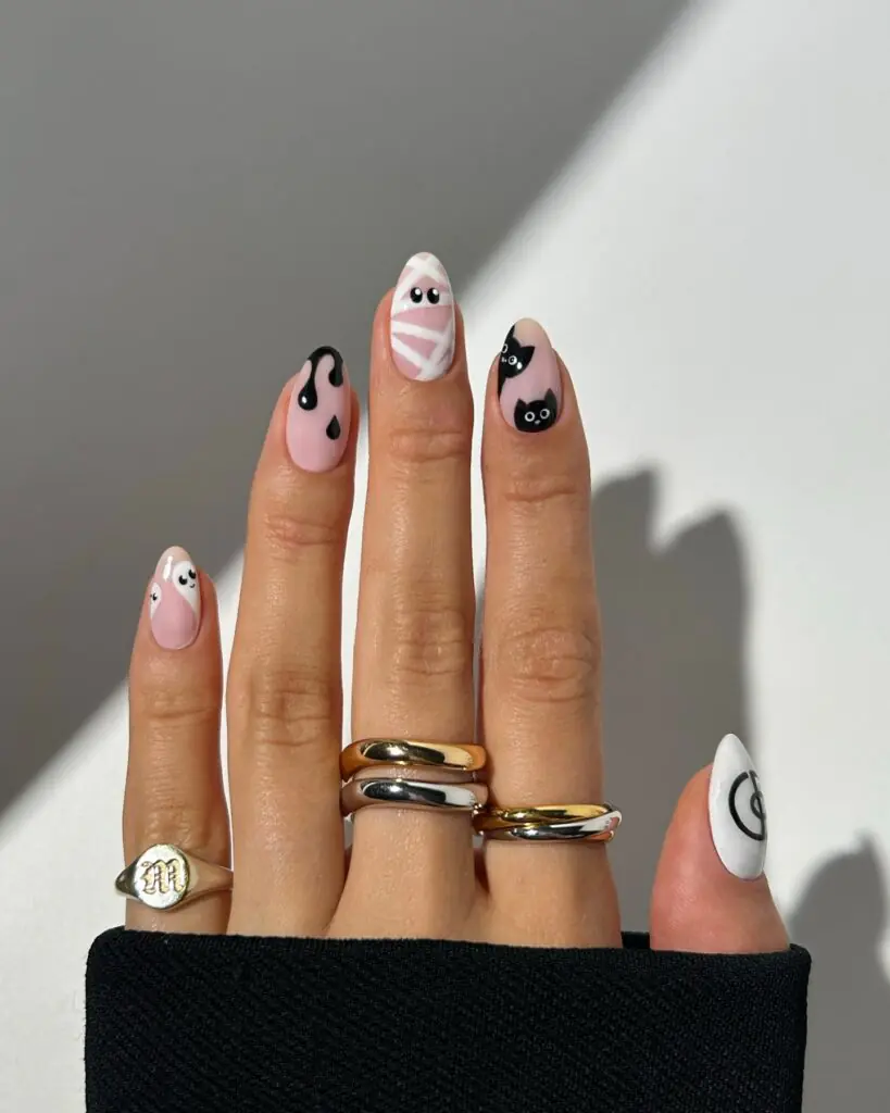 A milky nude base, slim black tips, and one or two tiny ghosts are subtle enough for errands and polished enough for an October dinner. If a full character set feels like too much, this is the sweet middle ground: a little seasonal personality without taking over your look.
