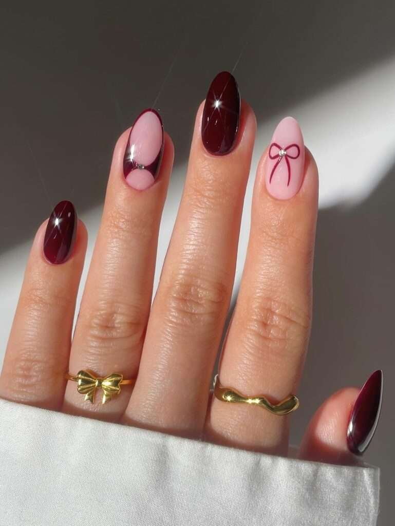 Burgundy and Pink French Contrast. Take the classic French manicure and turn the contrast up: use a sheer pink base, deep burgundy tips, and one charming bow or jewel accent. The shape stays clean, so the color does all the seasonal work. This is one of the most versatile October nail designs here because it can be worn at work, on a date, or with a party outfit.