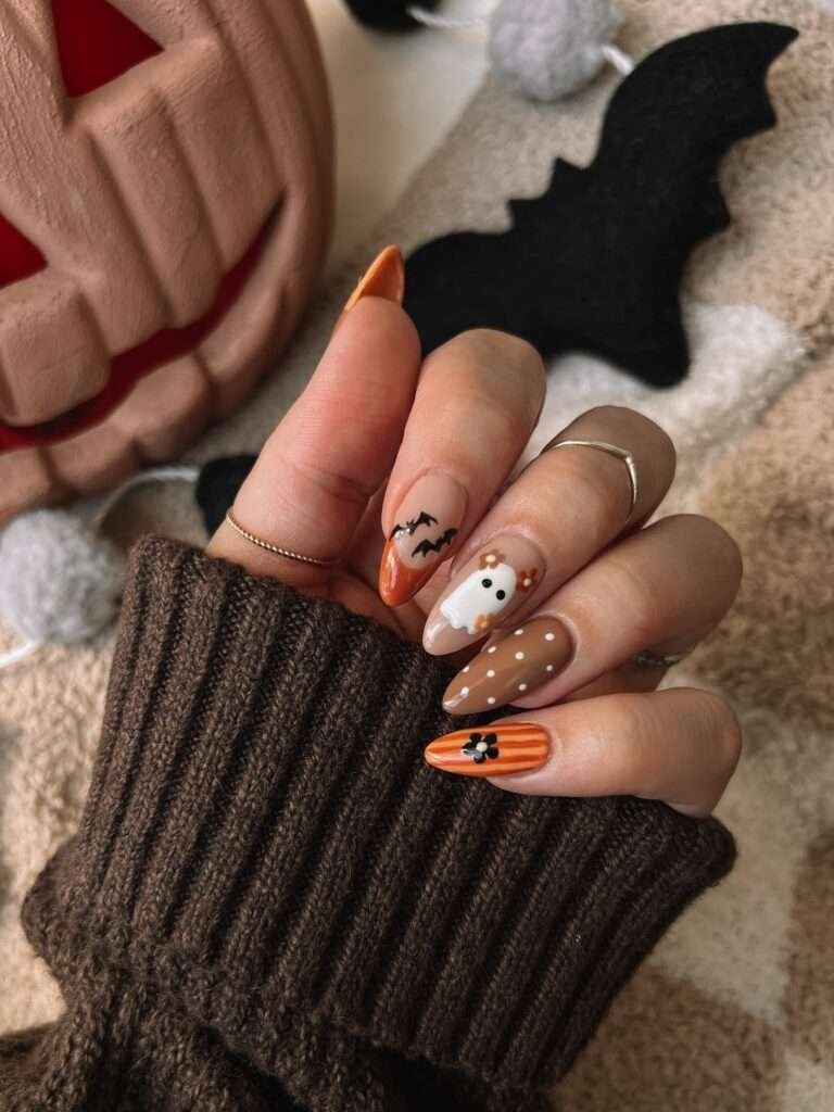 Chocolate Bat Sweater Nails. A matte top coat on the brown nails and glossy accents on the art create a subtle texture contrast that photographs beautifully.