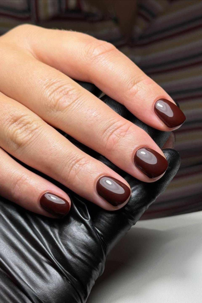 Espresso brown nails are for those moments when you want something darker than chocolate but aren't quite ready to commit to black.
Inspired by the deep color of freshly brewed coffee, this nearly black-brown shade feels sophisticated, minimal, and a little mysterious.
I find espresso particularly appealing for November because it works with the richer colors we naturally start wearing this time of year. Think black trousers, dark-wash denim, tailored wool coats, and chunky cream sweaters.