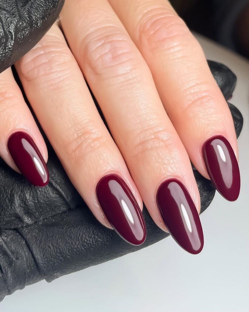 This is plum’s dressier cousin. Oxblood is a red with enough brown and depth to look almost black indoors, then flash wine in daylight. With a long almond shape and a mirror-like top coat, it’s the one I would book before a dinner, a wedding season catch-up or any evening where you want your hands to look finished.