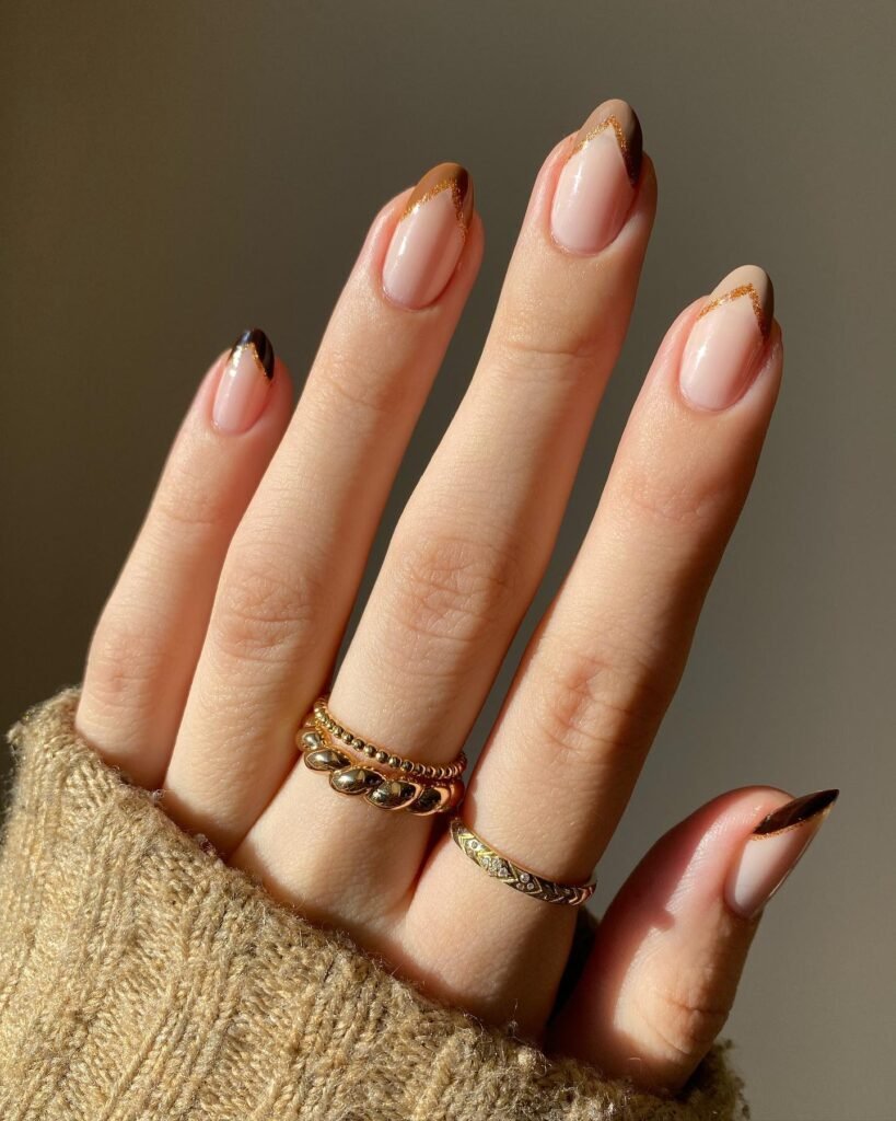This one is for the reader who wants nail art but is nervous about it. Two nails in glossy espresso frame two sheer blush nails with burgundy petals and a tiny gem at the base. It’s the right amount of detail: you notice it up close, but it won’t clash with anything.