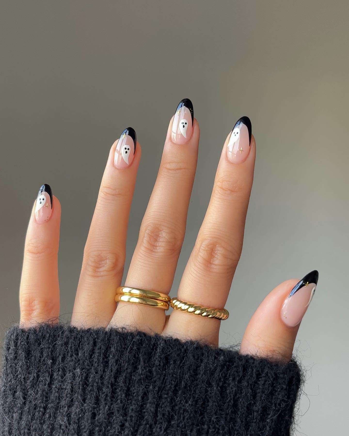 A black French edge already feels a little mysterious; add a tiny ghost and it becomes a wearable Halloween classic. The nude base keeps the design airy, while the dark tips frame short nails beautifully. It works at a Halloween party and still looks right with a blazer on Tuesday.