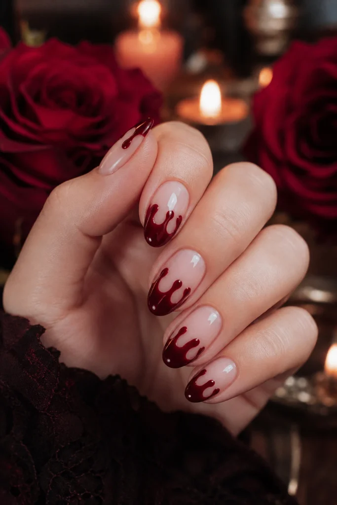 Deep wine-red drips over a nude or pale-pink base feel more gothic romance than costume-shop blood. This design has a little drama and a lot of polish, making it a lovely choice for a party, concert, or October night out.