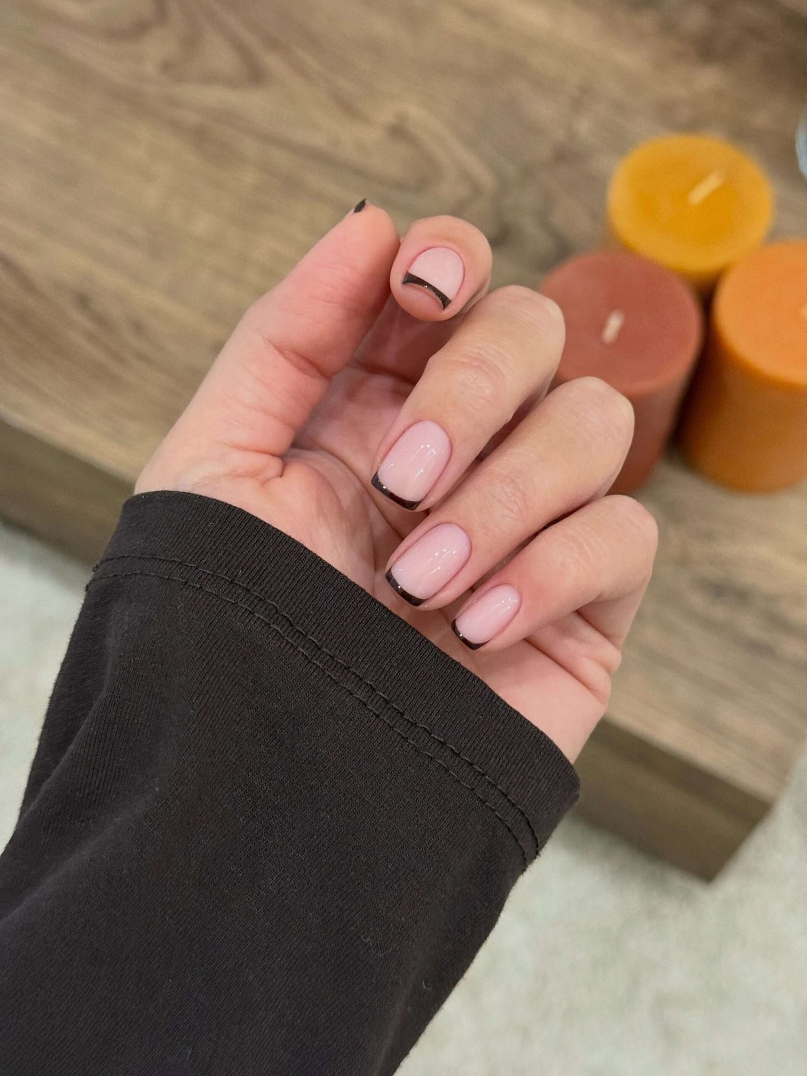 These short nails feature a soft pink-nude base with sleek black French tips.
The thin black tips add a subtle Halloween feel without looking too spooky or bold.
The short, rounded-square shape keeps the manicure clean, chic, and easy to wear.
I love this look for a minimal Halloween manicure that still feels effortlessly stylish.