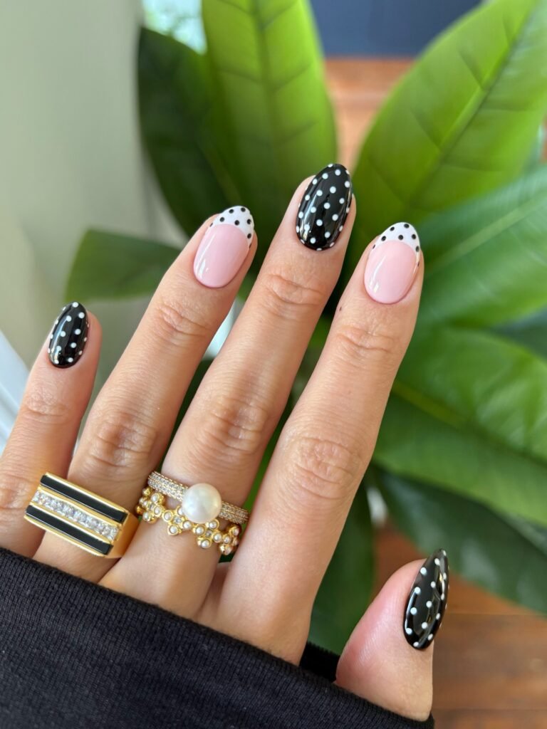 Black with white dots, plus a sheer pink French tip with black dots on a white edge. It’s graphic, and it’s the one set on this list that isn’t warm. If you like a monochrome look or you’re dressing for a party in November, it’s an easy way to stand out without adding colour.